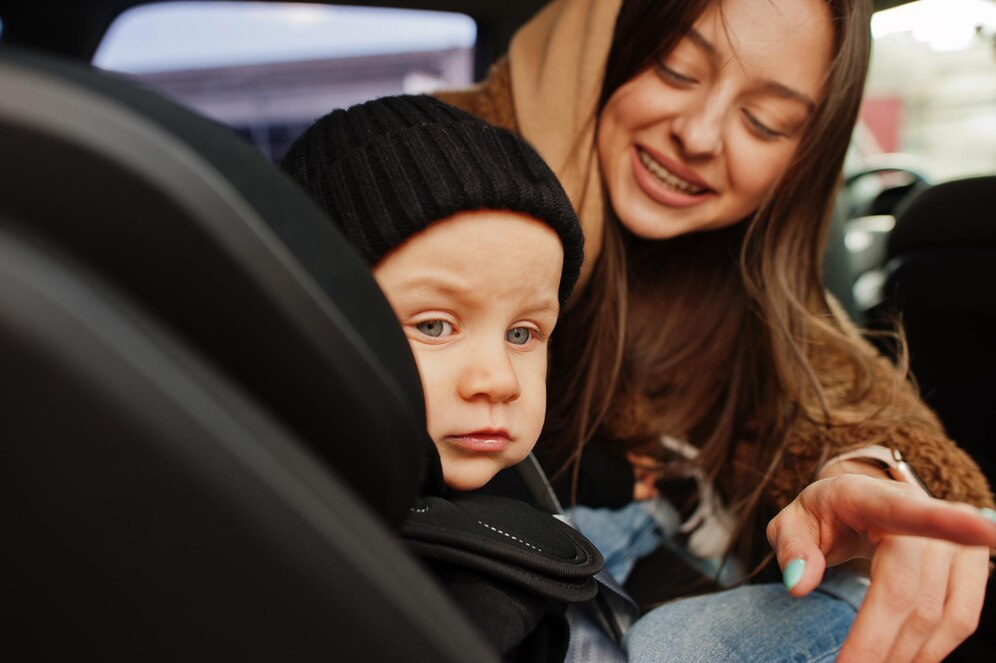 Mother and a baby on a booster seat