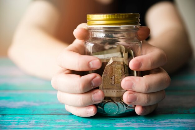 Child holding a jar of money